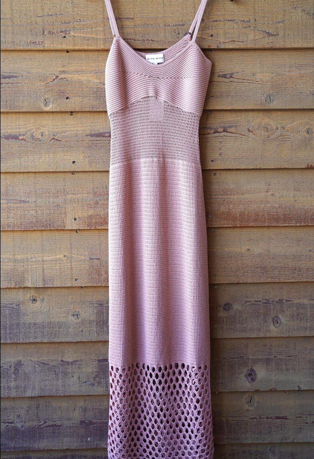 Salmon knit midi dress with thin straps and an open net-pattern hem.